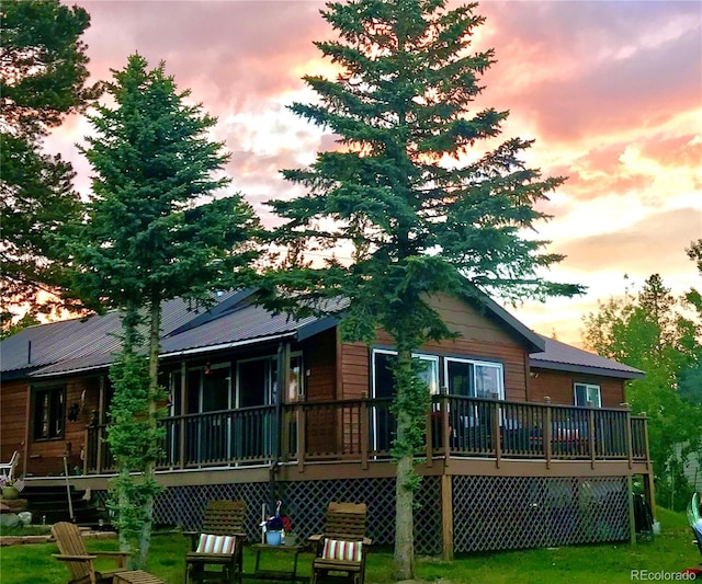 1348 Gcr 64, Grand Lake, CO 80447 - back of property at dusk featuring a deck, a yard, and metal roof