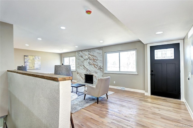 entrance foyer with light wood finished floors, visible vents, recessed lighting, and baseboards