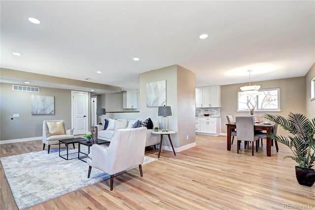 living area featuring recessed lighting, visible vents, baseboards, and light wood-style floors