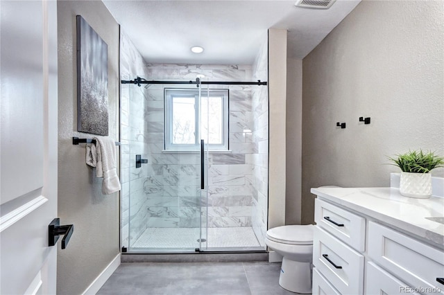 full bathroom featuring a shower stall, toilet, vanity, and baseboards