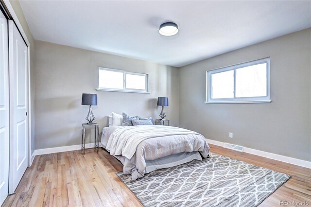 bedroom with baseboards and light wood finished floors