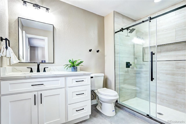 full bath with vanity, toilet, and a stall shower