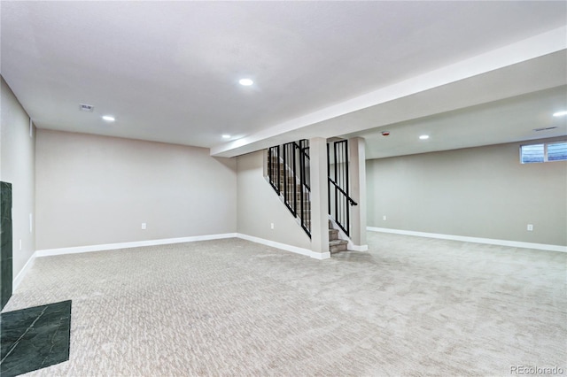 below grade area with recessed lighting, stairway, baseboards, and carpet