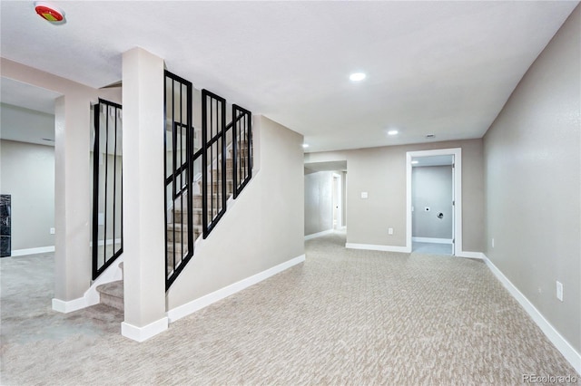 basement with stairway, recessed lighting, carpet flooring, and baseboards