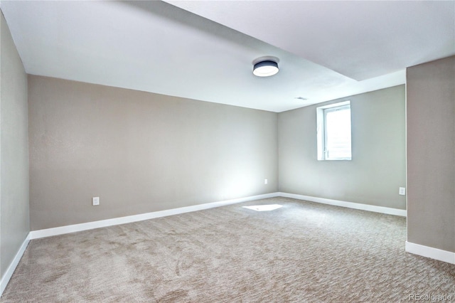 unfurnished room featuring carpet flooring and baseboards