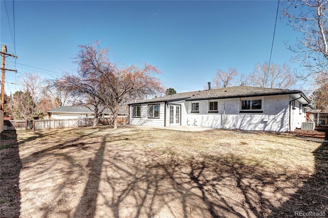 rear view of property featuring a patio, french doors, fence, and central AC