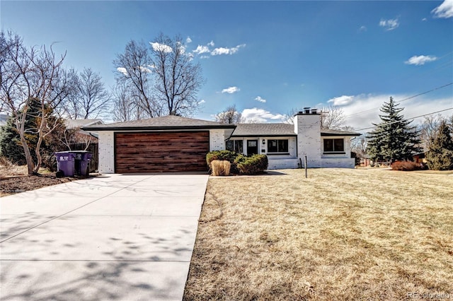 single story home with a front yard, an attached garage, driveway, and a chimney