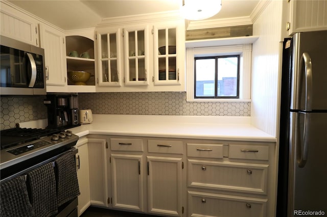 kitchen with tasteful backsplash, glass insert cabinets, stainless steel appliances, light countertops, and open shelves