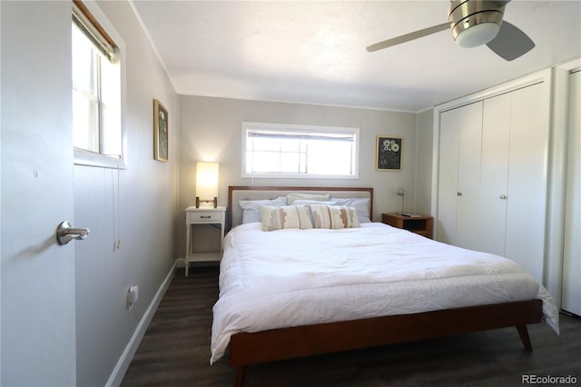 bedroom with dark wood-style flooring, a closet, a ceiling fan, and baseboards