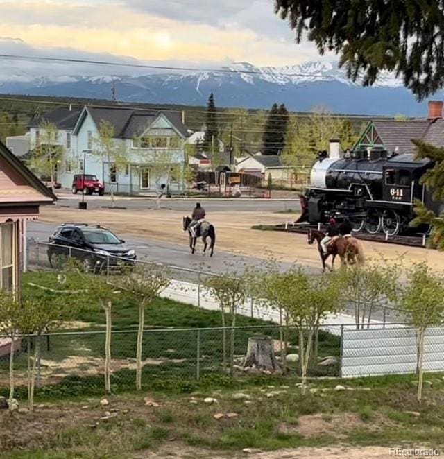 surrounding community featuring fence and a mountain view