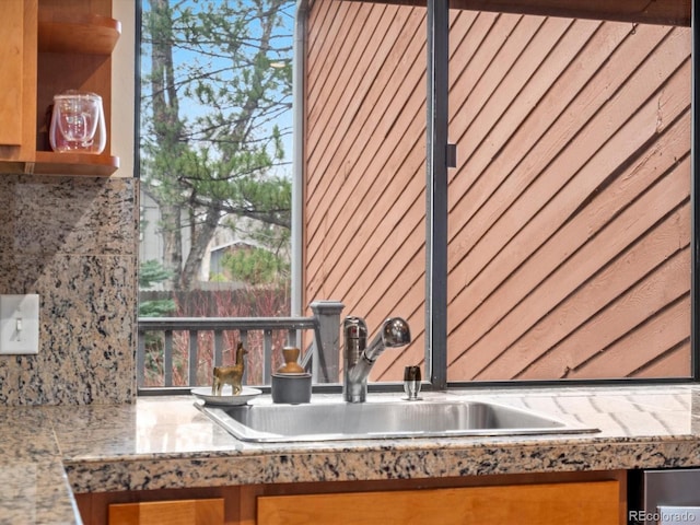 kitchen with brown cabinetry and a sink