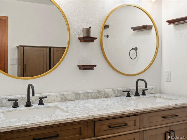 full bathroom with double vanity and a sink