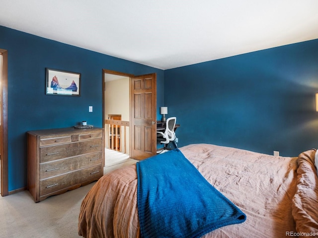 bedroom with carpet floors and baseboards