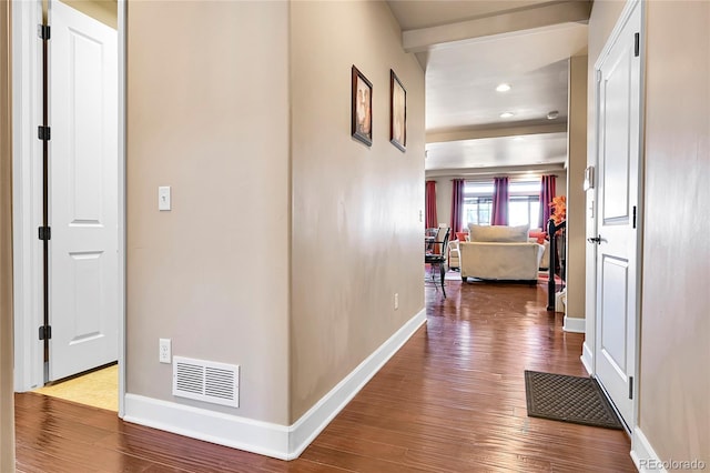 hallway with recessed lighting, visible vents, baseboards, and wood finished floors