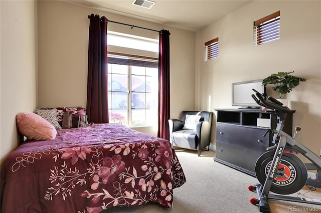 carpeted bedroom featuring visible vents