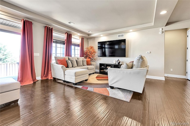 living area with visible vents, baseboards, and dark wood-style flooring