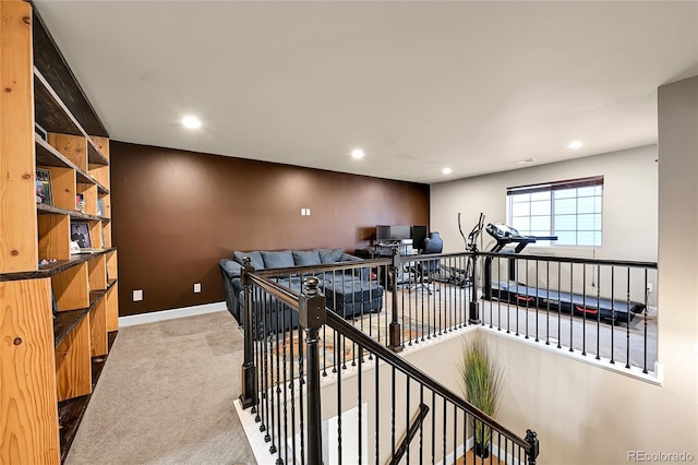 hallway featuring recessed lighting, an upstairs landing, and carpet flooring