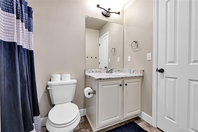 full bathroom featuring tile patterned floors, baseboards, toilet, and vanity