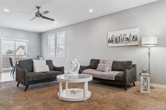 living room featuring plenty of natural light, ceiling fan, and carpet floors