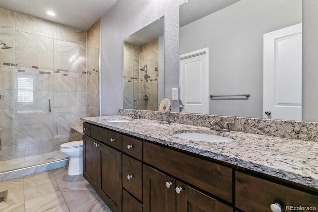 bathroom with vanity, toilet, and an enclosed shower