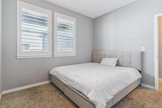 bedroom featuring light carpet and multiple windows