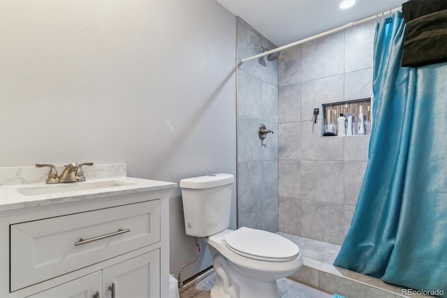 bathroom featuring toilet, vanity, and walk in shower