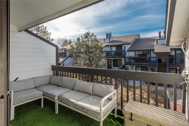 balcony featuring an outdoor living space and a residential view