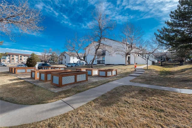 view of property's community featuring a yard and a residential view