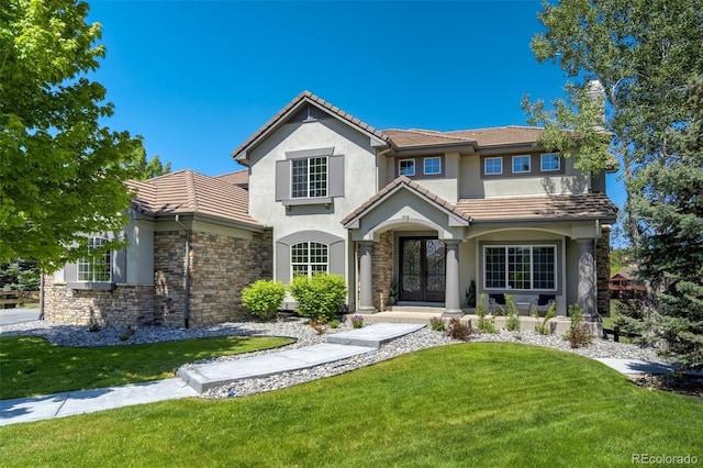 24031 E Hinsdale Pl, Aurora, CO 80016 - view of front facade featuring stucco siding, stone siding, a tiled roof, and french doors
