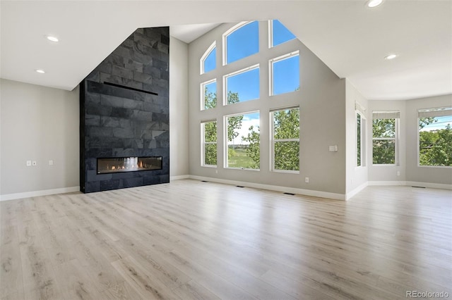 24031 E Hinsdale Pl, Aurora, CO 80016 - unfurnished living room with a fireplace, wood finished floors, baseboards, and recessed lighting