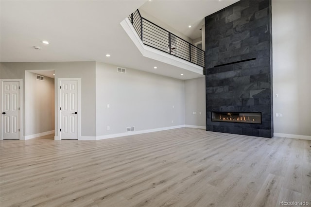 24031 E Hinsdale Pl, Aurora, CO 80016 - unfurnished living room with a fireplace, wood finished floors, recessed lighting, and baseboards