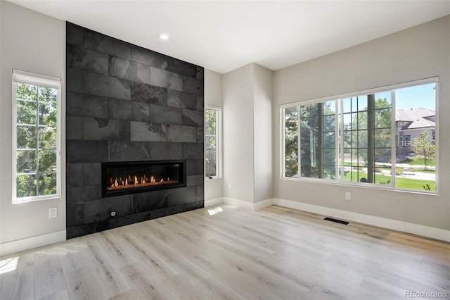 24031 E Hinsdale Pl, Aurora, CO 80016 - unfurnished living room featuring a fireplace, wood finished floors, baseboards, and recessed lighting