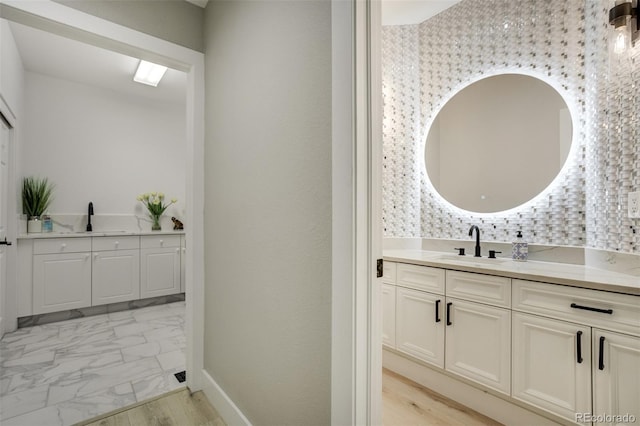 24031 E Hinsdale Pl, Aurora, CO 80016 - bathroom with vanity, marble finish flooring, and baseboards