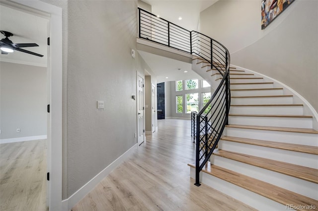 24031 E Hinsdale Pl, Aurora, CO 80016 - staircase with wood finished floors, baseboards, ceiling fan, a towering ceiling, and recessed lighting
