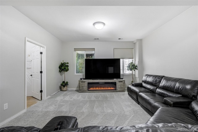 24031 E Hinsdale Pl, Aurora, CO 80016 - living area featuring carpet flooring, a glass covered fireplace, and baseboards