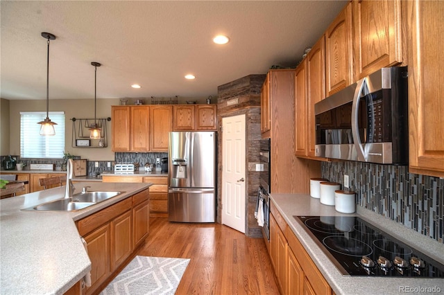 14962 Williams St, Thornton, CO 80602 - kitchen with black appliances, a sink, recessed lighting, tasteful backsplash, and light wood-type flooring