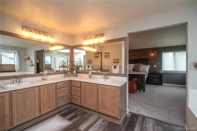 14962 Williams St, Thornton, CO 80602 - ensuite bathroom featuring double vanity, plenty of natural light, and wood finished floors