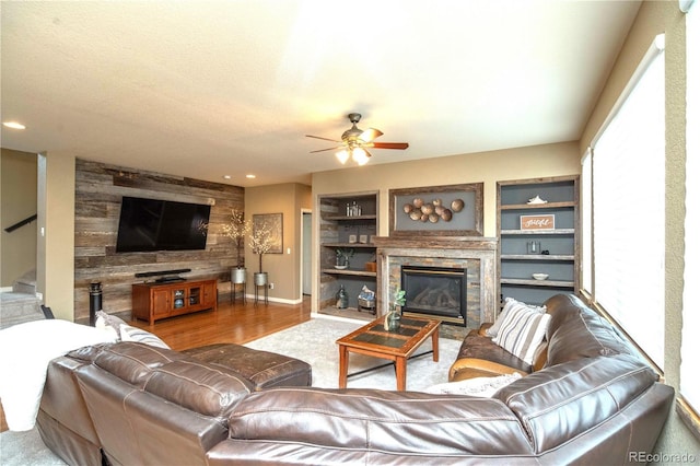 14962 Williams St, Thornton, CO 80602 - living area with ceiling fan, a glass covered fireplace, stairway, wood finished floors, and built in features