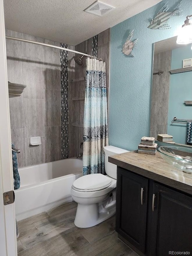 14962 Williams St, Thornton, CO 80602 - bathroom with a textured wall, a textured ceiling, vanity, wood finished floors, and shower / tub combo with curtain