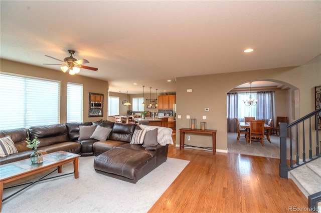 14962 Williams St, Thornton, CO 80602 - living room featuring arched walkways, plenty of natural light, light wood finished floors, a chandelier, and recessed lighting