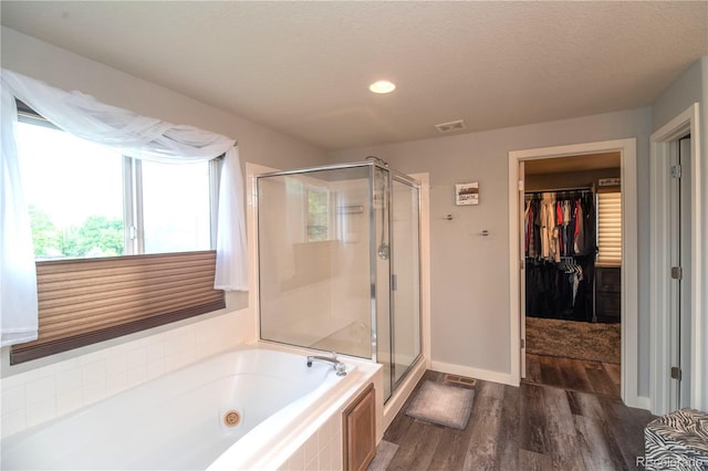 14962 Williams St, Thornton, CO 80602 - bathroom featuring a shower stall, a whirlpool tub, wood finished floors, a walk in closet, and recessed lighting