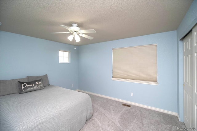 14962 Williams St, Thornton, CO 80602 - carpeted bedroom with a closet, baseboards, a textured ceiling, and a ceiling fan