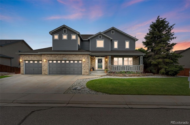 14962 Williams St, Thornton, CO 80602 - view of front of property featuring concrete driveway, covered porch, and a garage