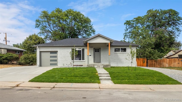 bungalow-style house featuring a garage, concrete driveway, fence, and a front lawn