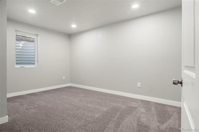 carpeted empty room featuring recessed lighting, visible vents, and baseboards