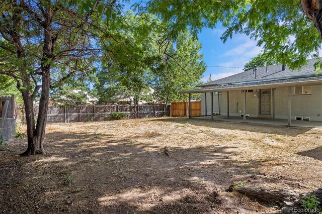 view of yard featuring a patio area and a fenced backyard