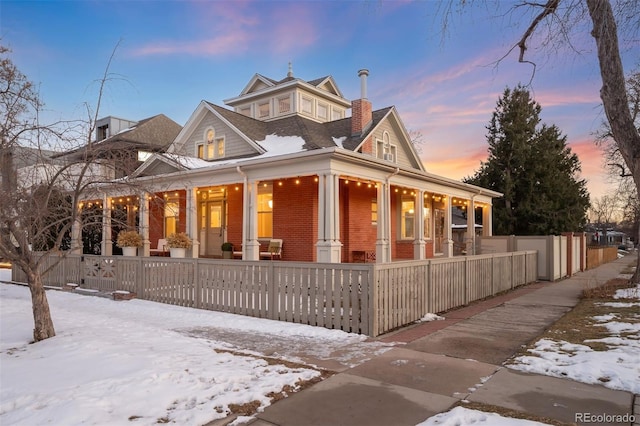 view of snow covered exterior with covered porch