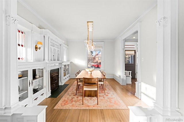 dining space with hardwood / wood-style floors and ornamental molding