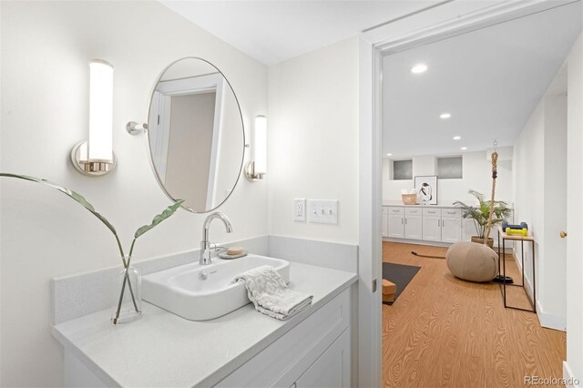 bathroom featuring hardwood / wood-style flooring and vanity