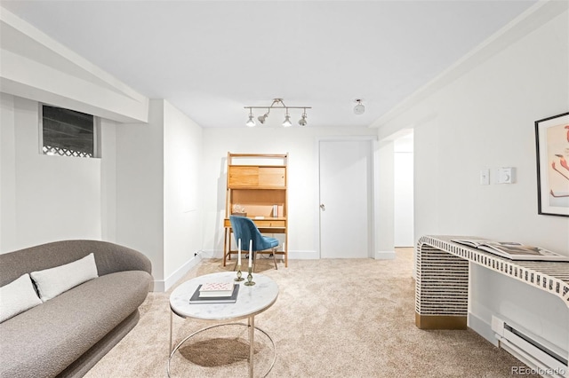 carpeted living room with a baseboard radiator and rail lighting